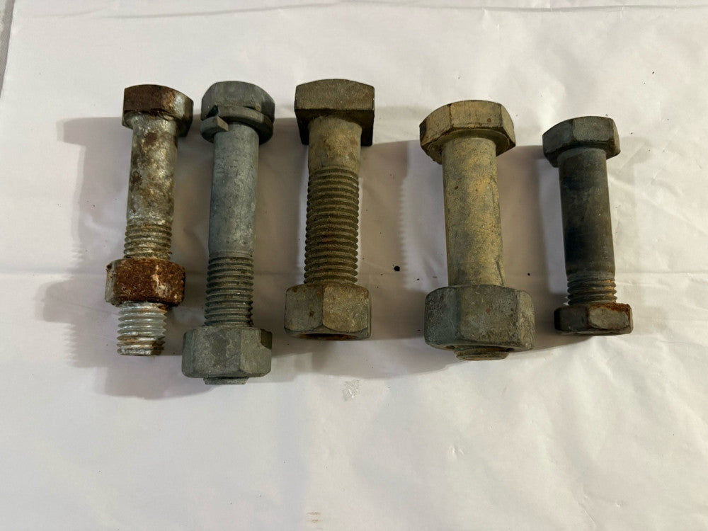 Five galvanized bolts and nuts 3.5 inch to 5 inches long one to 1.5 inches wide