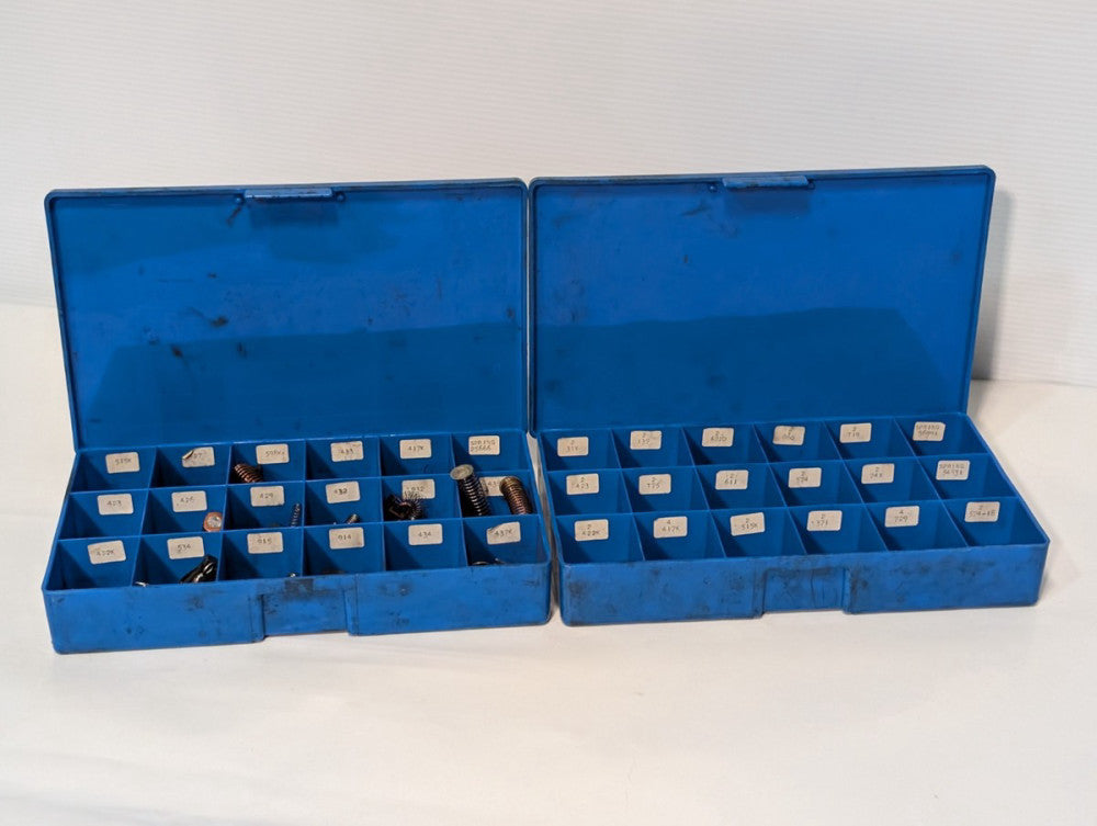 Large lot of assorted motor brushes as shown, two blue organizers included
